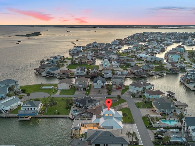 1311 Oahu Dr, Tiki Island, TX 77554 - aerial view of property's location with a large body of water and nearby suburban area