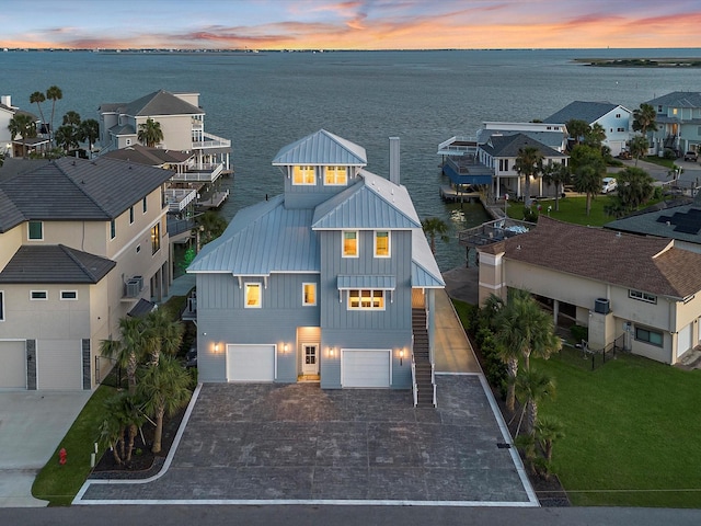 1311 Oahu Dr, Tiki Island, TX 77554 - aerial perspective of suburban area featuring a large body of water