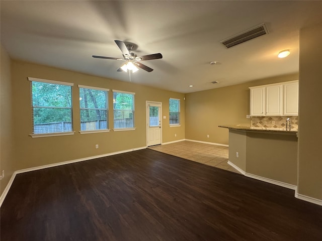 118 N Camellia Grove Cir, The Woodlands, TX 77382 - unfurnished living room with wood finished floors, ceiling fan, and baseboards