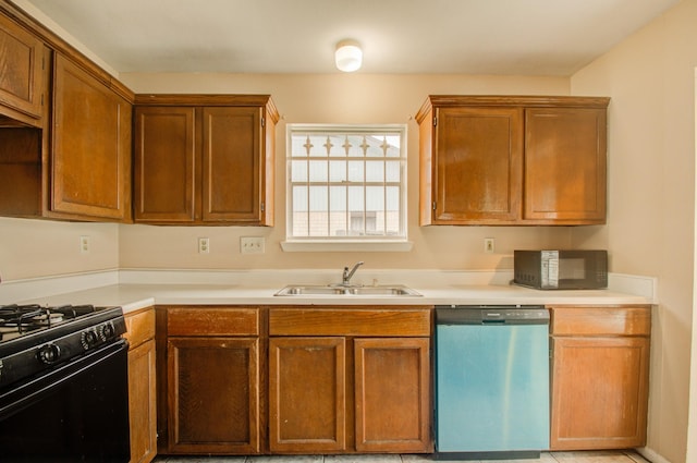 9470 Gulf Bridge St, Houston, TX 77075 - kitchen featuring black appliances, a sink, light countertops, and brown cabinets