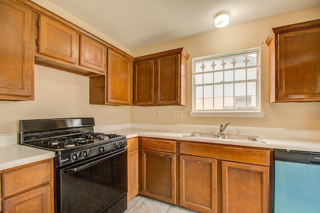 9470 Gulf Bridge St, Houston, TX 77075 - kitchen with black range with gas cooktop, dishwashing machine, a sink, light countertops, and brown cabinets