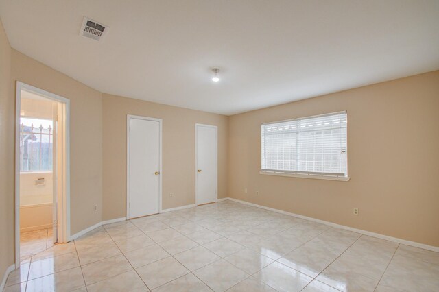 9470 Gulf Bridge St, Houston, TX 77075 - unfurnished room with light tile patterned floors and baseboards