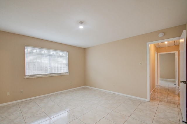 9470 Gulf Bridge St, Houston, TX 77075 - empty room with attic access, a smoke detector, light tile patterned floors, and baseboards