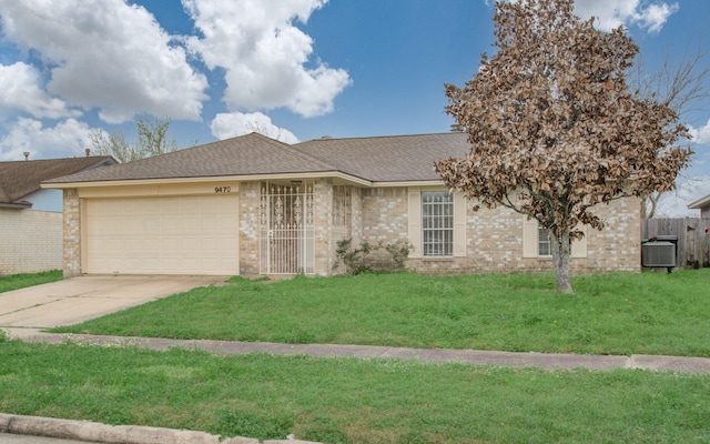 9470 Gulf Bridge St, Houston, TX 77075 - view of front of house with concrete driveway, a garage, brick siding, central AC unit, and roof with shingles
