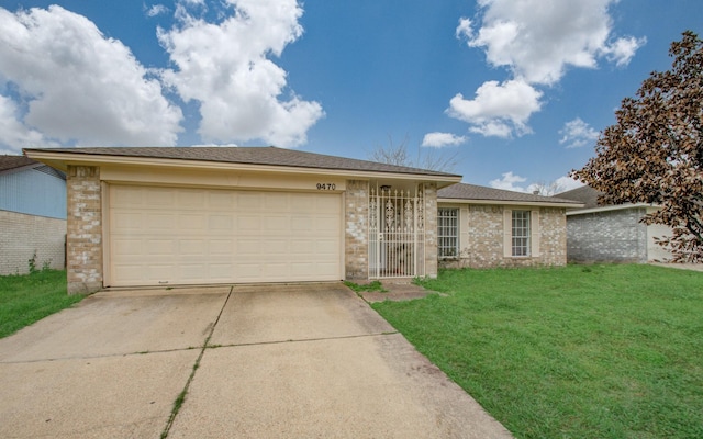 9470 Gulf Bridge St, Houston, TX 77075 - view of front of house featuring concrete driveway, a front yard, an attached garage, and brick siding