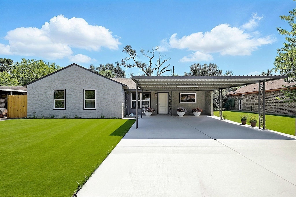 5614 Northridge Dr, Houston, TX 77033 - ranch-style house with driveway, stone siding, and an attached carport
