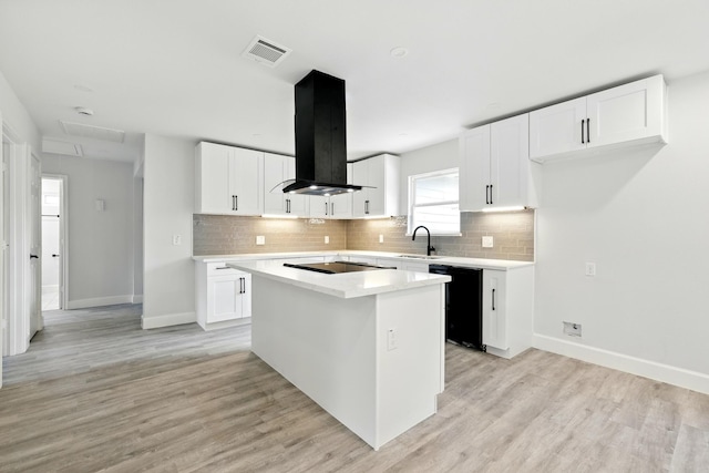 5614 Northridge Dr, Houston, TX 77033 - kitchen featuring black appliances, island range hood, a sink, a kitchen island, and backsplash