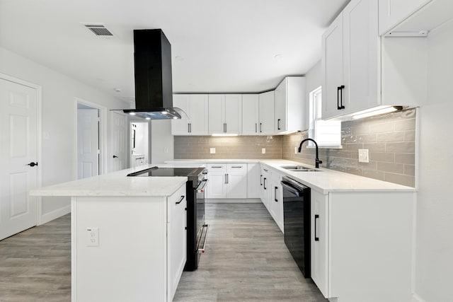 5614 Northridge Dr, Houston, TX 77033 - kitchen featuring island exhaust hood, a sink, black appliances, a center island, and decorative backsplash