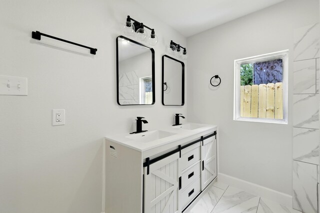 5614 Northridge Dr, Houston, TX 77033 - full bath featuring marble finish floors, double vanity, and baseboards