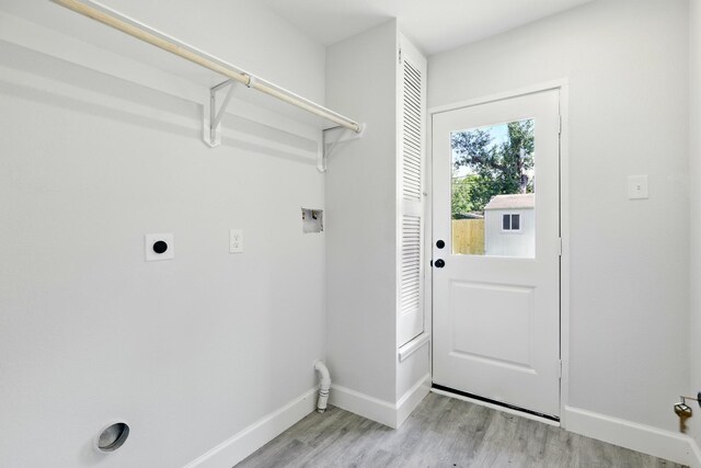 5614 Northridge Dr, Houston, TX 77033 - washroom featuring hookup for an electric dryer, baseboards, light wood-style floors, and washer hookup