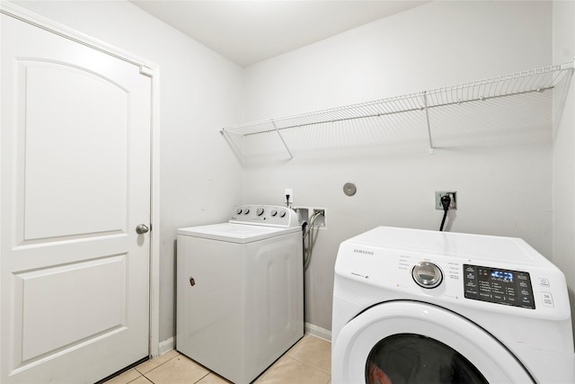 11020 Panther Ct, Houston, TX 77099 - clothes washing area with independent washer and dryer, light tile patterned flooring, and baseboards