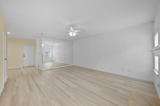 9850 Pagewood Ln Unit 1208, Houston, TX 77042 - unfurnished living room with a ceiling fan, light wood-type flooring, and baseboards