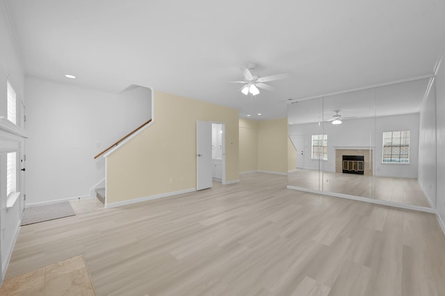 9850 Pagewood Ln Unit 1208, Houston, TX 77042 - unfurnished living room featuring a fireplace, a ceiling fan, stairway, baseboards, and recessed lighting