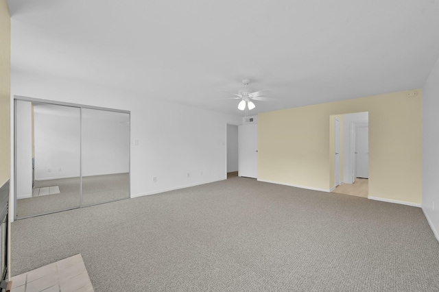 9850 Pagewood Ln Unit 1208, Houston, TX 77042 - unfurnished living room featuring ceiling fan, carpet flooring, and baseboards