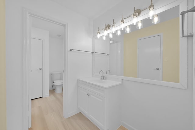 9850 Pagewood Ln Unit 1208, Houston, TX 77042 - bathroom with wood finished floors, vanity, and toilet