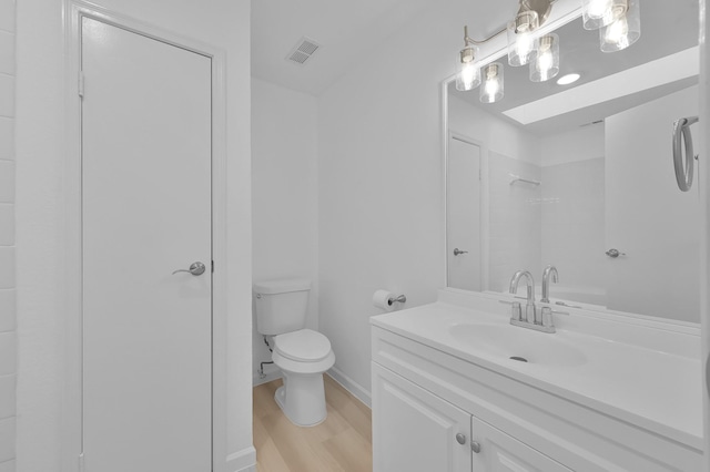 9850 Pagewood Ln Unit 1208, Houston, TX 77042 - bathroom featuring wood finished floors, toilet, baseboards, and vanity