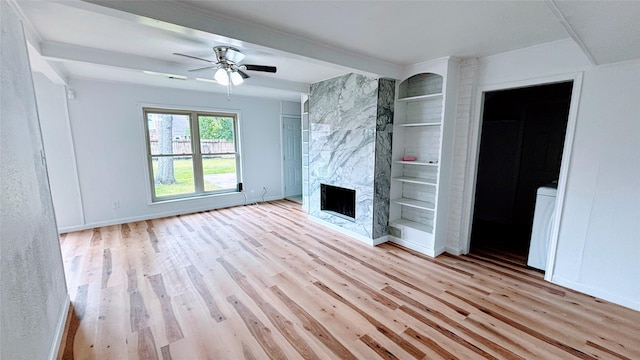 14406 Roundstone Ln, Houston, TX 77015 - unfurnished living room featuring wood finished floors, a fireplace, a ceiling fan, baseboards, and beam ceiling