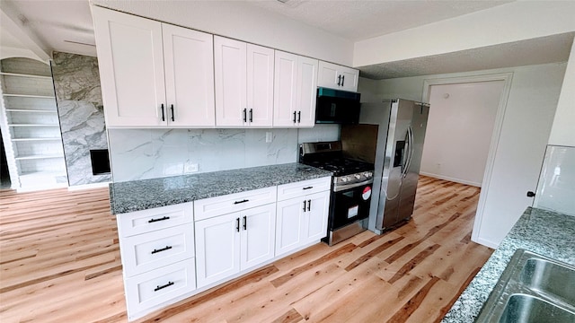 14406 Roundstone Ln, Houston, TX 77015 - kitchen featuring appliances with stainless steel finishes, light wood-style floors, white cabinets, tasteful backsplash, and stone countertops