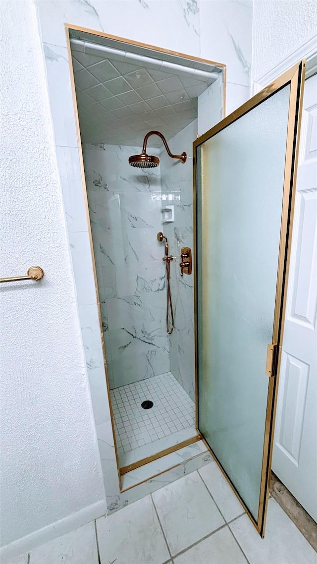 14406 Roundstone Ln, Houston, TX 77015 - full bathroom featuring a marble finish shower and marble look tiles