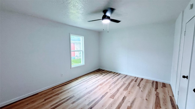 14406 Roundstone Ln, Houston, TX 77015 - unfurnished bedroom with light wood-type flooring, baseboards, and ceiling fan