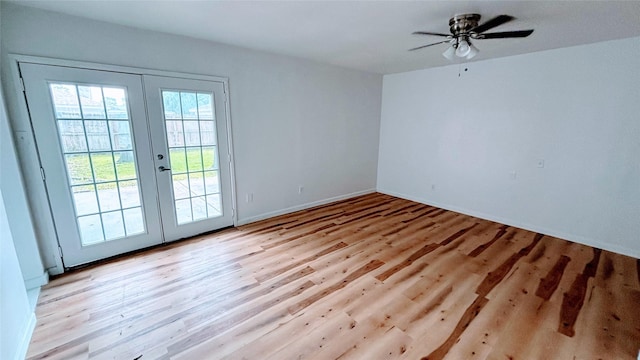 14406 Roundstone Ln, Houston, TX 77015 - spare room featuring french doors, light wood-type flooring, a ceiling fan, and baseboards