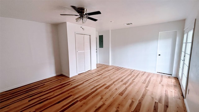 14406 Roundstone Ln, Houston, TX 77015 - spare room featuring light wood-type flooring, electric panel, a ceiling fan, and baseboards