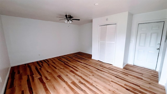 14406 Roundstone Ln, Houston, TX 77015 - unfurnished bedroom featuring wood finished floors, a closet, baseboards, and ceiling fan