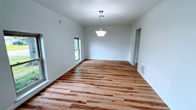 14406 Roundstone Ln, Houston, TX 77015 - unfurnished dining area with wood finished floors, baseboards, and ornamental molding