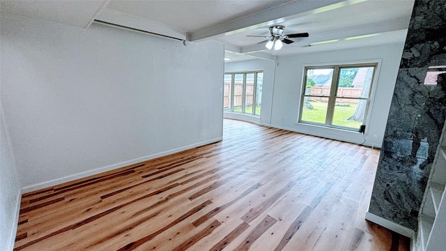 14406 Roundstone Ln, Houston, TX 77015 - spare room featuring beam ceiling, wood finished floors, a ceiling fan, and baseboards