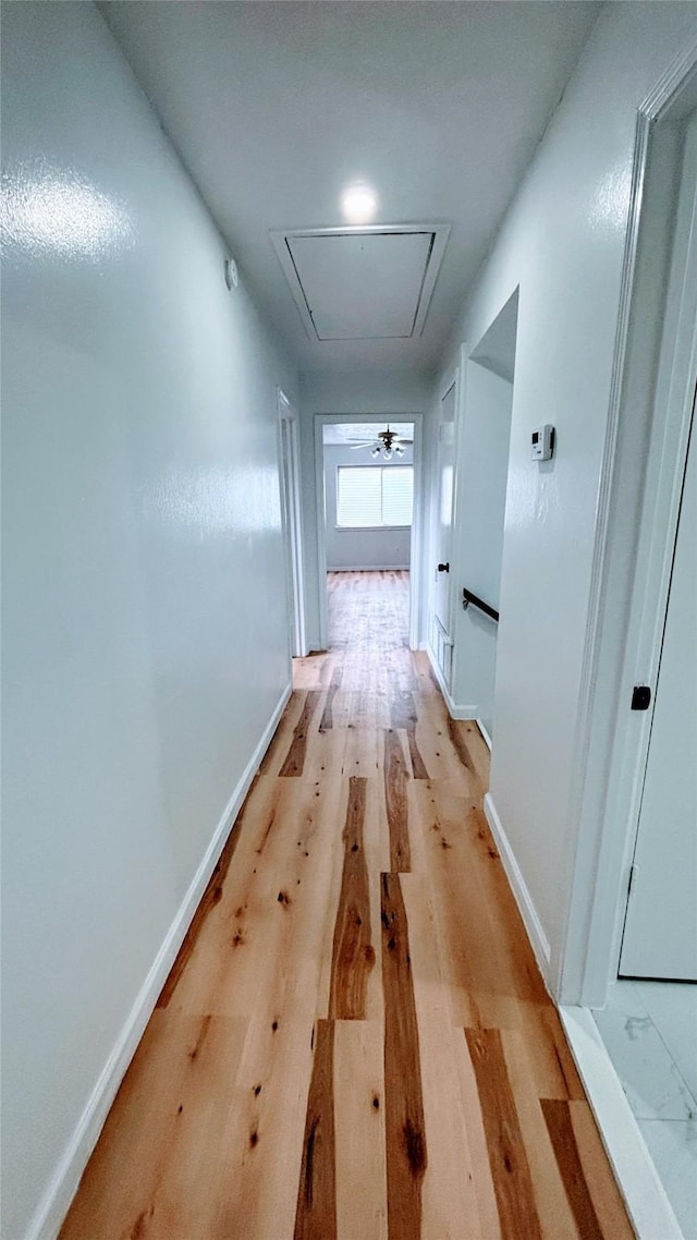 14406 Roundstone Ln, Houston, TX 77015 - hallway with attic access, light wood-style flooring, and baseboards