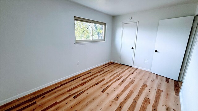 14406 Roundstone Ln, Houston, TX 77015 - unfurnished bedroom featuring light wood-style floors and baseboards