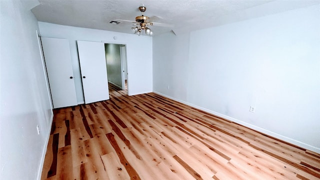 14406 Roundstone Ln, Houston, TX 77015 - unfurnished bedroom with wood finished floors, baseboards, and ceiling fan
