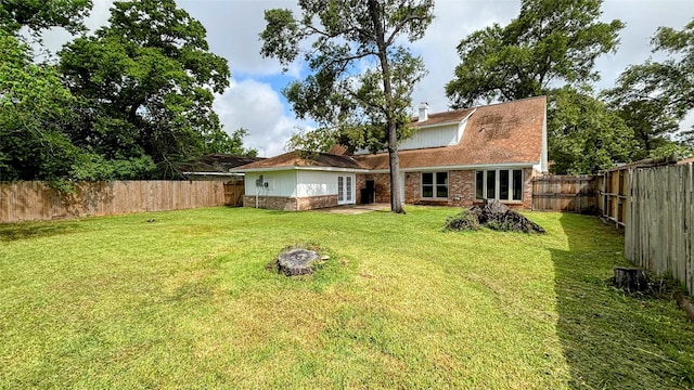 14406 Roundstone Ln, Houston, TX 77015 - back of property featuring brick siding, a chimney, and french doors