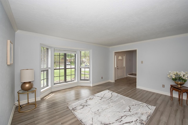 2030 Cutter Dr, League City, TX 77573 - spare room featuring wood finished floors, ornamental molding, baseboards, and a textured ceiling