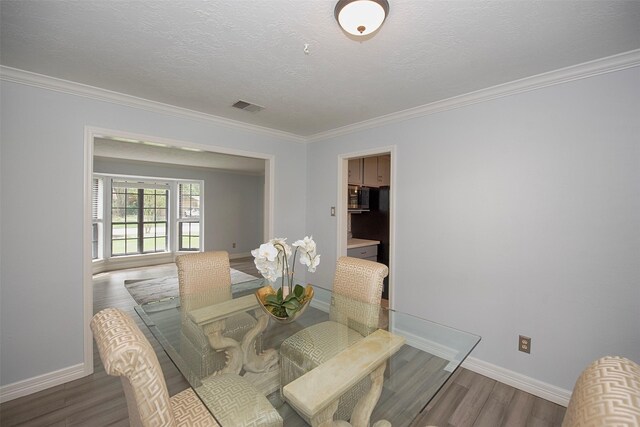 2030 Cutter Dr, League City, TX 77573 - dining area featuring wood finished floors, crown molding, and baseboards