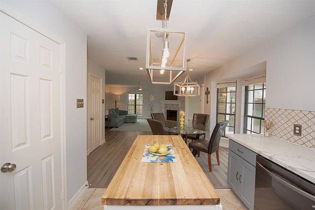 2030 Cutter Dr, League City, TX 77573 - dining space featuring a stone fireplace, plenty of natural light, baseboards, a chandelier, and recessed lighting