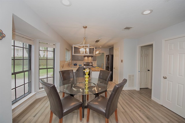 2030 Cutter Dr, League City, TX 77573 - dining room featuring a chandelier, light wood finished floors, baseboards, and recessed lighting