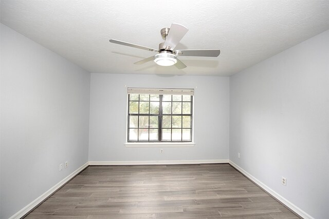 2030 Cutter Dr, League City, TX 77573 - empty room with a ceiling fan, wood finished floors, and baseboards