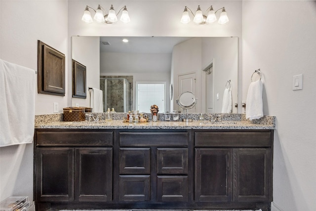 bathroom featuring a shower stall and double vanity