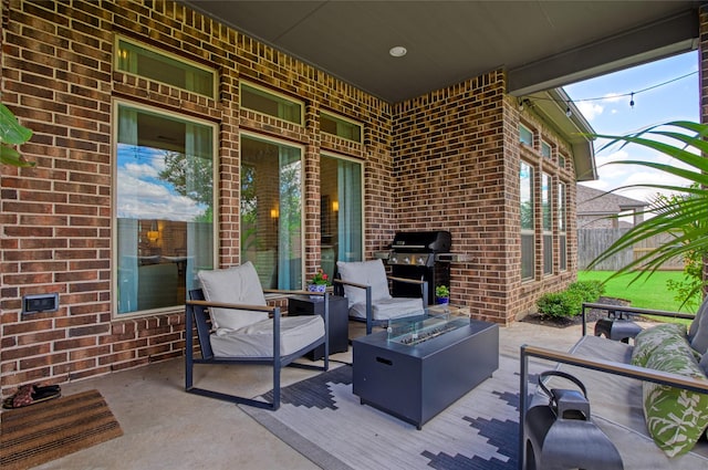 view of patio featuring grilling area and an outdoor living space with a fire pit