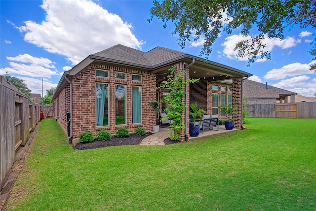 back of house featuring brick siding and a patio area