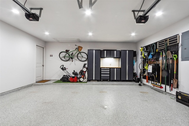garage featuring a garage door opener and recessed lighting