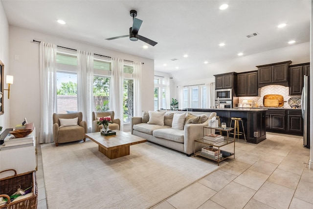 living room with ceiling fan, recessed lighting, and light tile patterned floors