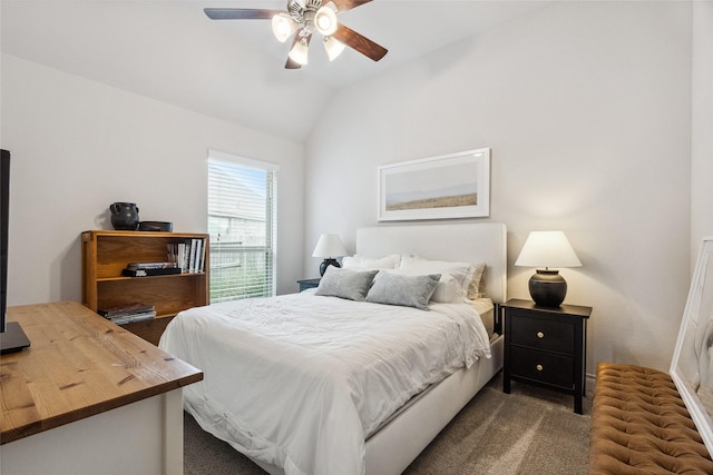 bedroom featuring lofted ceiling, dark colored carpet, and a ceiling fan