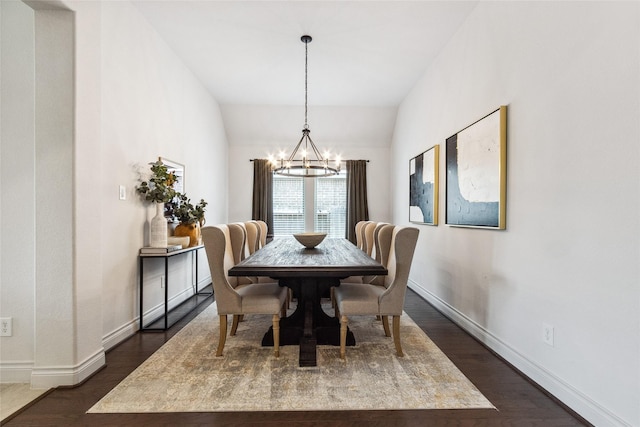 dining space featuring a chandelier, dark wood-style floors, and baseboards