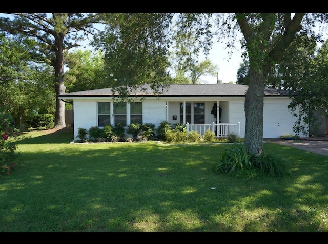 123 25th Ave N, Texas City, TX 77590 - ranch-style house featuring an attached garage, a front yard, brick siding, and covered porch