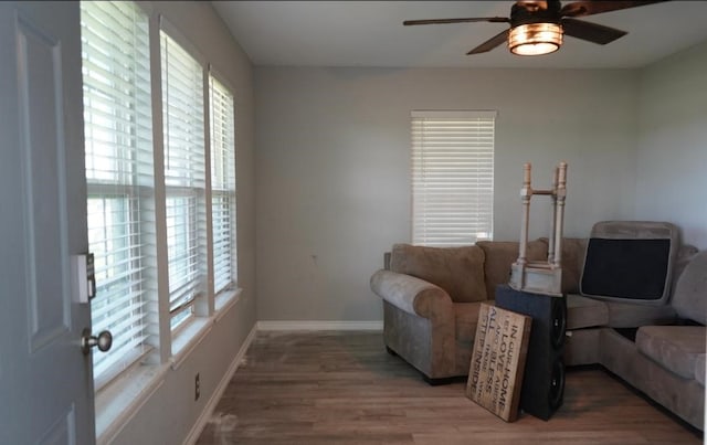 123 25th Ave N, Texas City, TX 77590 - living room with a ceiling fan, baseboards, and wood finished floors