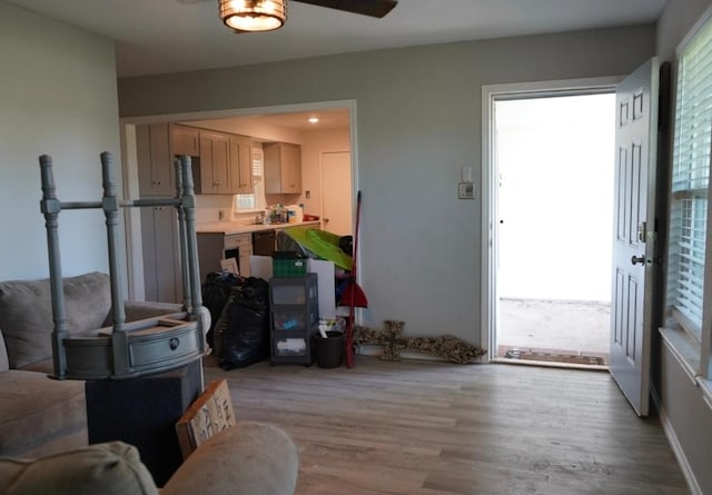 123 25th Ave N, Texas City, TX 77590 - living area with light wood-type flooring, ceiling fan, and a wood stove