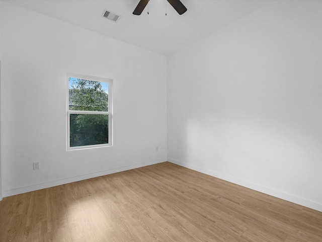 empty room featuring a ceiling fan, wood finished floors, and baseboards