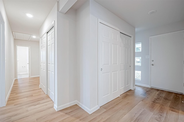 103 Anna St, Tomball, TX 77375 - corridor with attic access, light wood-style floors, and baseboards